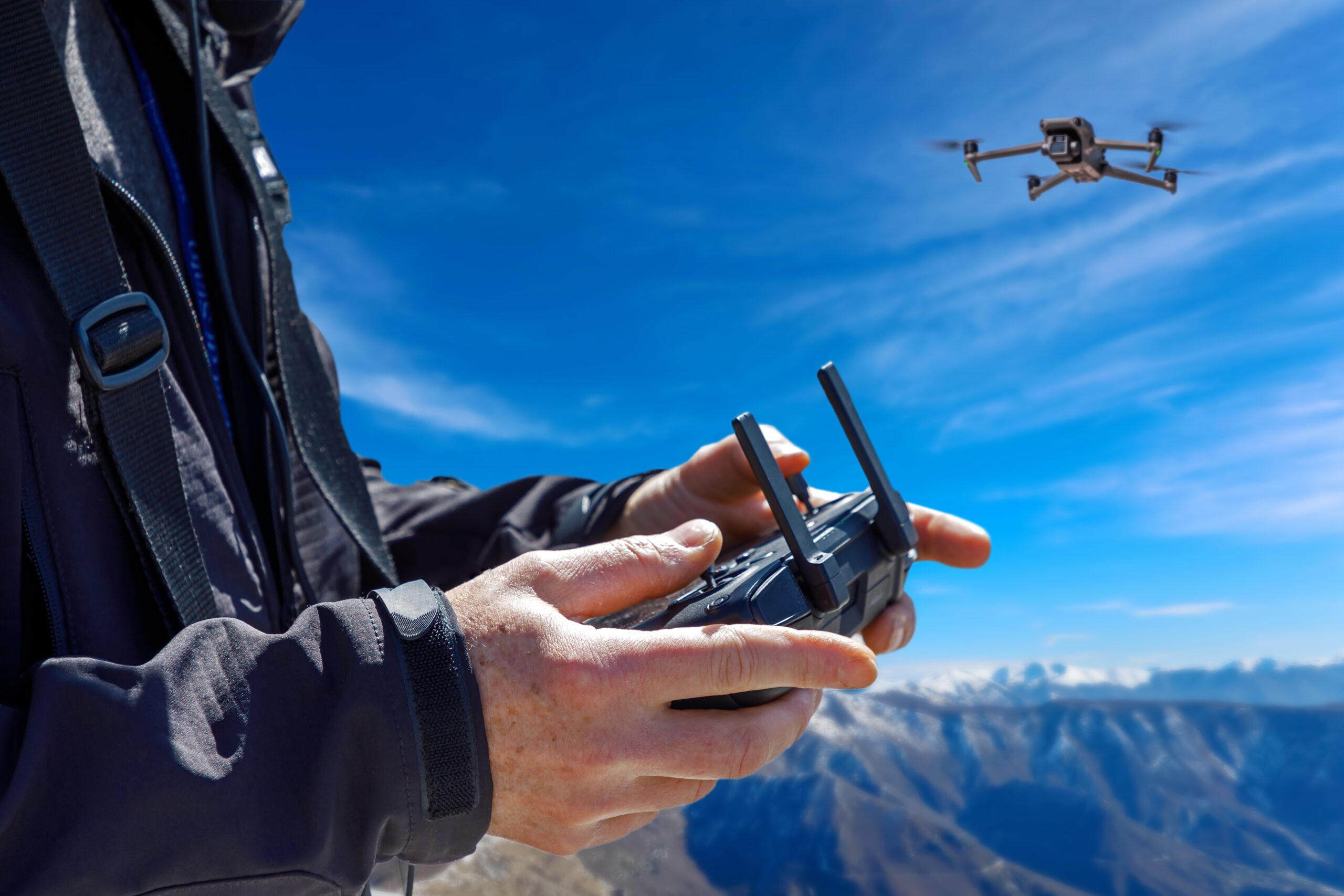 Pilot remotely controls the flight of a drone while making aerial cinematic footage